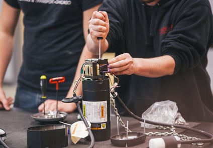 Image of Two people working on wiring 