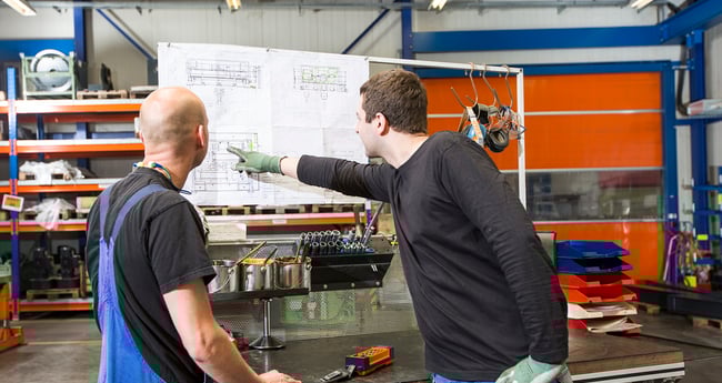 Image Two Men Looking, and pointing at Chart 