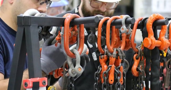 Image of two men working together on chain equipment