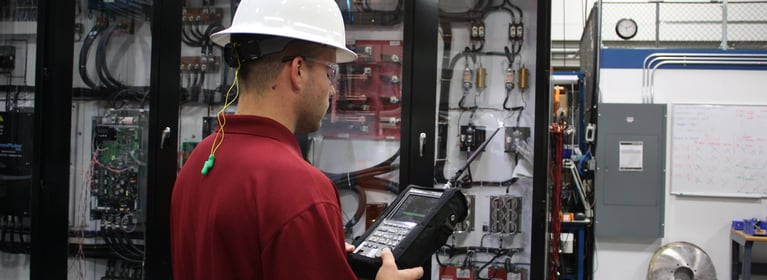 Image of Man in Hardhat and Goggles working on Equipment