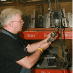 Image of man working on crane inspection